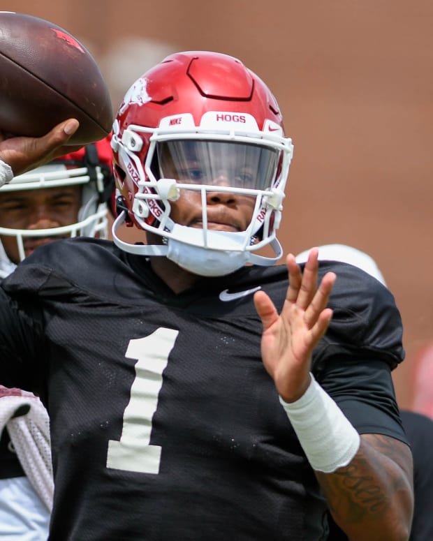 Razorbacks quarterback KJ Jefferson throws a pass in practice on the outdoor fields at the football center in Fayetteville, Arkansas.